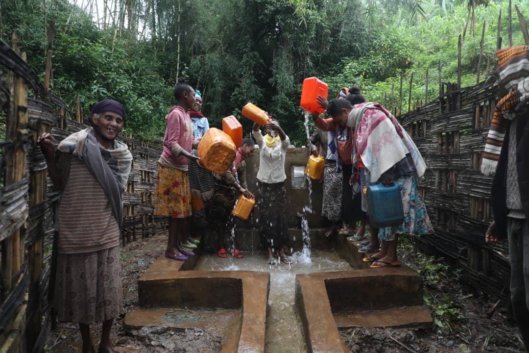 Ethiopian community gathering water at a well funded by Keffa Coffee